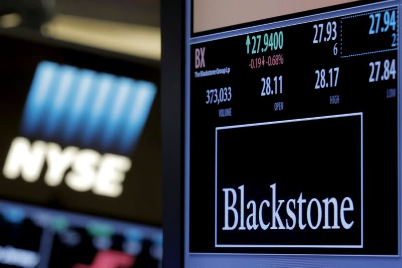 FILE PHOTO: The ticker and trading information for Blackstone Group is displayed at the post where it is traded on the floor of the New York Stock Exchange