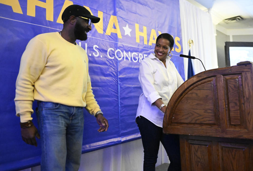 Rep. Jahana Hayes, D-Conn., smiles as she looks at her husband, Milford Hayes, left, as she addresses supporters at her election-night event in Waterbury, Conn., Tuesday, Nov. 8, 2022. Hayes is running for re-election in Connecticut's 5th Congressional District against Republican candidate George Logan. (AP Photo/Jessica Hill)