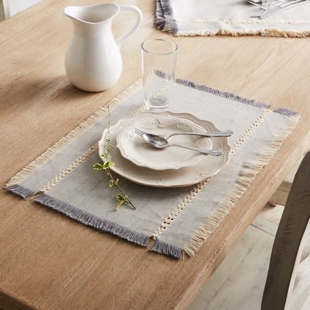 the grey placemat under a place setting