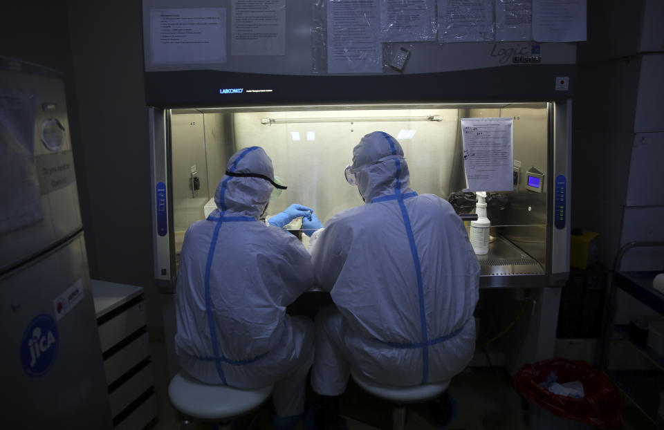 Afghan lab technicians test samples at the Afghan-Japan Communicable Disease Hospital, treating COVID-19 patients in Kabul, Afghanistan, Tuesday June 30, 2020. (AP Photo/Rahmat Gul)