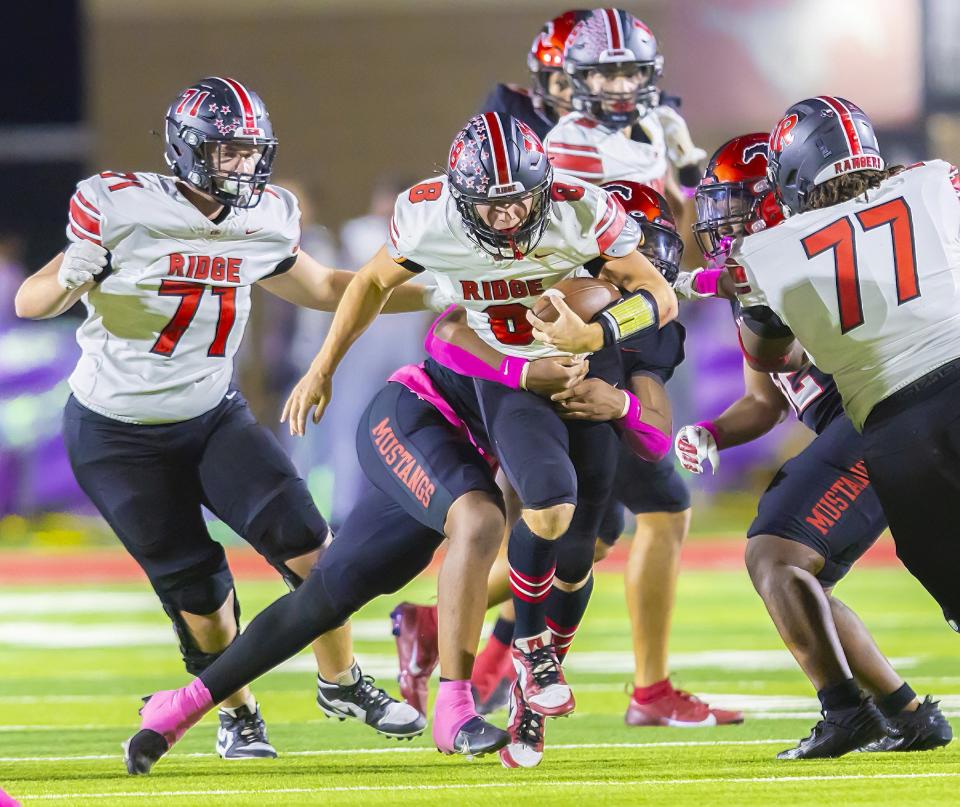 Vista Ridge QB Grant Anderson bolts up the middle for yards against Manor. Normally an outside linebacker, he was switched the QB when the starter got hurt. He accounted for 280 yards to earn player of the week honors.