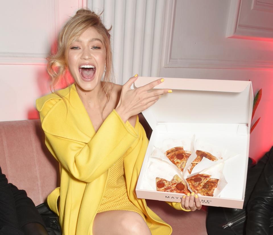 Gigi Hadid couldn’t resist the New York inspired pizza. Copyright: [Dave Bennett for Maybelline New York]
