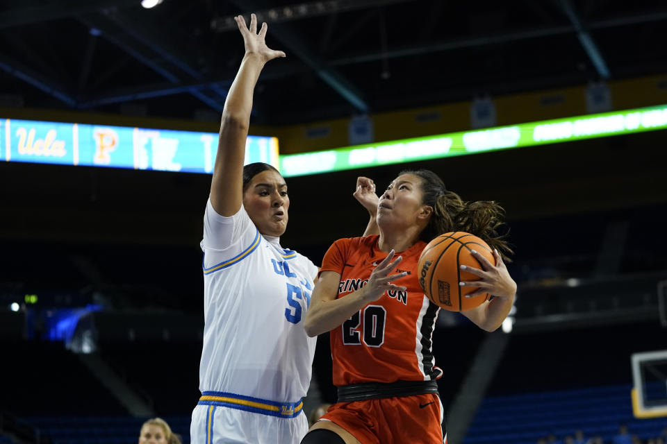 Princeton guard Kaitlyn Chen, right, shoots against UCLA center Lauren Betts during the first half of an NCAA college basketball game, Friday, Nov. 17, 2023, in Los Angeles. (AP Photo/Ryan Sun)