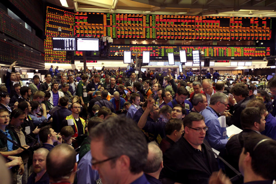 Traders signal offers at the Chicago Board of Trade.<p>Scott Olson/Getty Images</p>