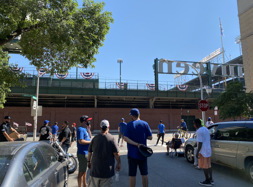 Fans wait out on Waveland Avenue for a ball to fly over the left field fence at Wrigley Field. (Yahoo Sports)