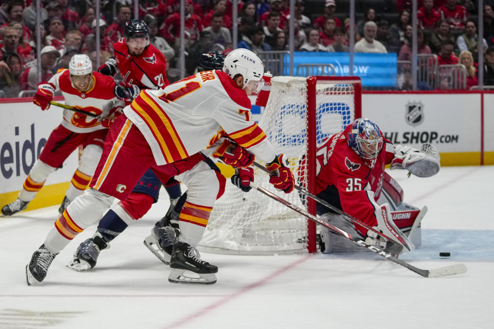 Calgary Flames center Walker Duehr has his shot deflected by Washington Capitals goaltender Darcy Kuemper (35) in the second period of an NHL hockey game, Monday, Oct. 16, 2023, in Washington. (AP Photo/Alex Brandon)