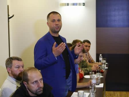 Prime Minister of the self-proclaimed Donetsk People's Republic Alexander Borodai (standing) speaks as he takes part in talks between representatives of OSCE, Ukraine, Russia and self-proclaimed Donetsk and Luhansk People's Republics in Donetsk June 27, 2014. REUTERS/Shamil Zhumatov/Files