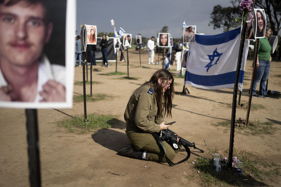An Israeli soldier weeps at the marker for a loved one kidnapped on Oct. 7 in a cross-border attack by Hamas at the Nova music festival, after a press conference at the site in Re'im, southern Israel, Friday, Jan. 5, 2024. (AP Photo/Maya Alleruzzo)