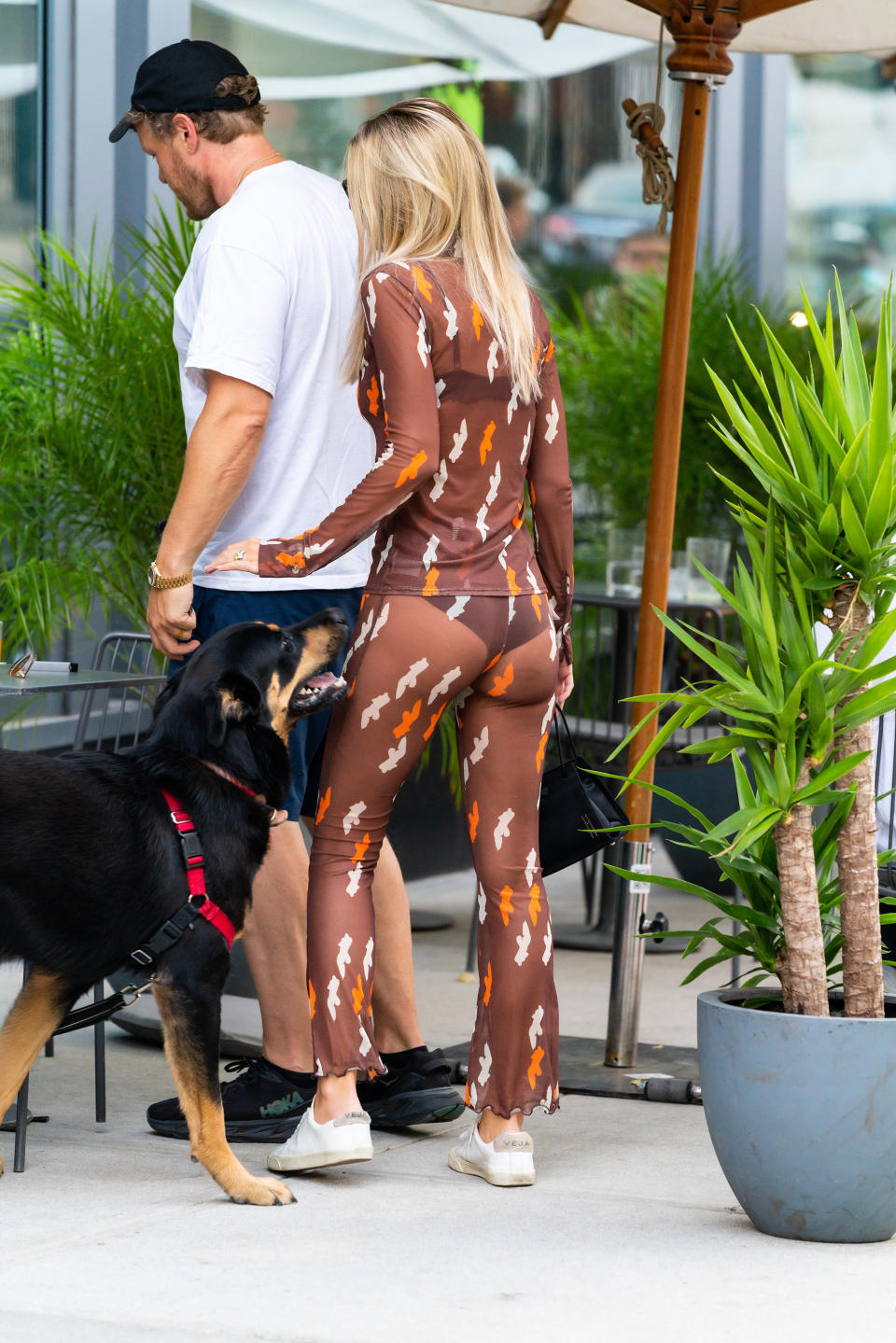 Emily Ratajkowski wearing an earth toned body suit meets her husband Sebastian Bear-McClard and dog Colombo for dinner at ATLA in the East Village.