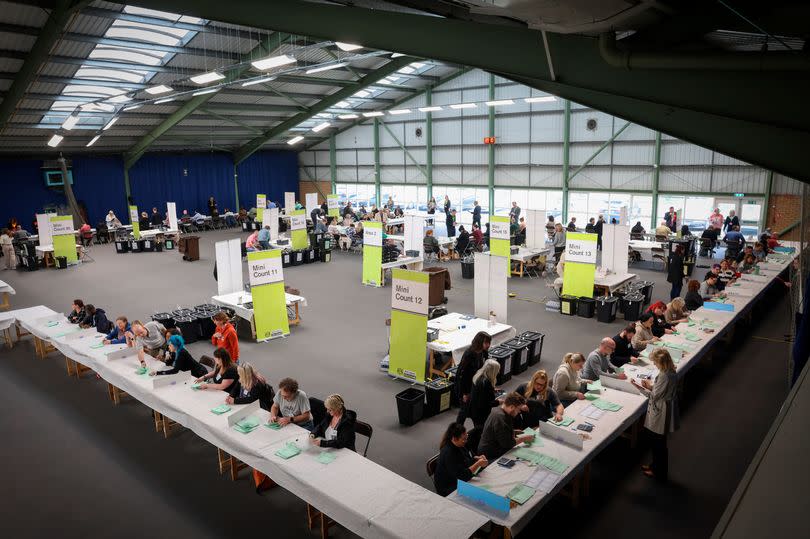 The count floor as verification takes place ahead of the East Midlands Mayoral election count. Rows of white tables are seen on the floor of the Nottingham Tennis Centre
