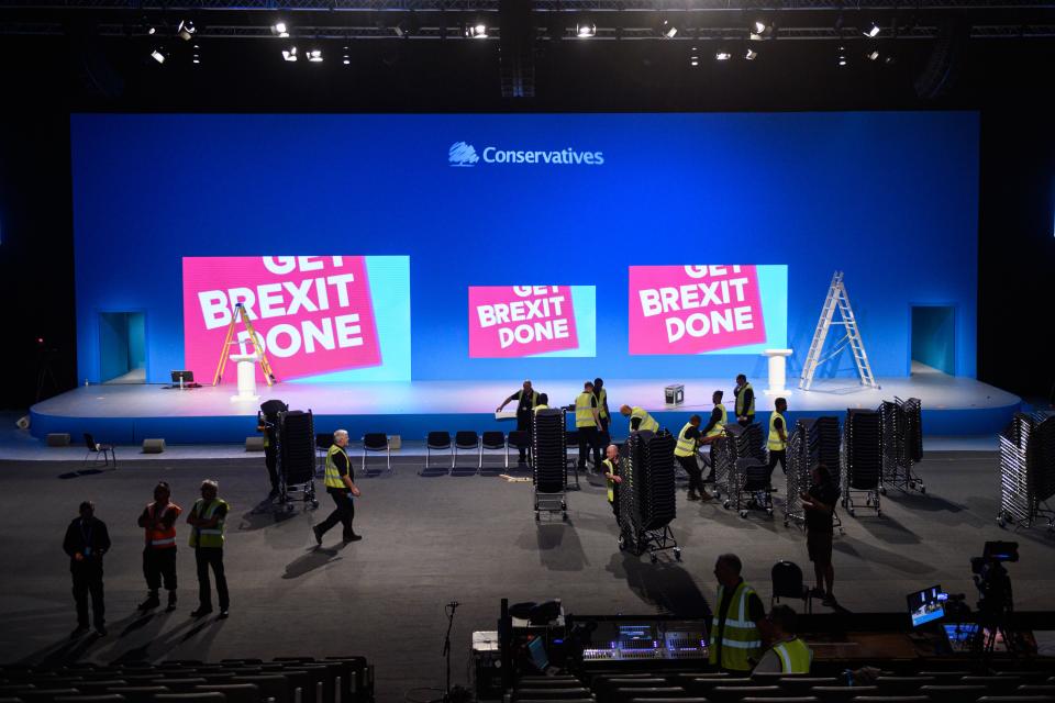 Workers help prepare an auditorium with Conservative Party branding inside Manchester Central convention centre, the venue of the annual Conservative Party conference, in Manchester, northwest England on September 28, 2019 on the eve of the start of the conference. - Embattled British Prime Minister Boris Johnson gathers his Conservative party Sunday for what could be its final conference before an election, and is set to be dominated by fighting talk on Brexit. (Photo by OLI SCARFF / AFP)        (Photo credit should read OLI SCARFF/AFP/Getty Images)