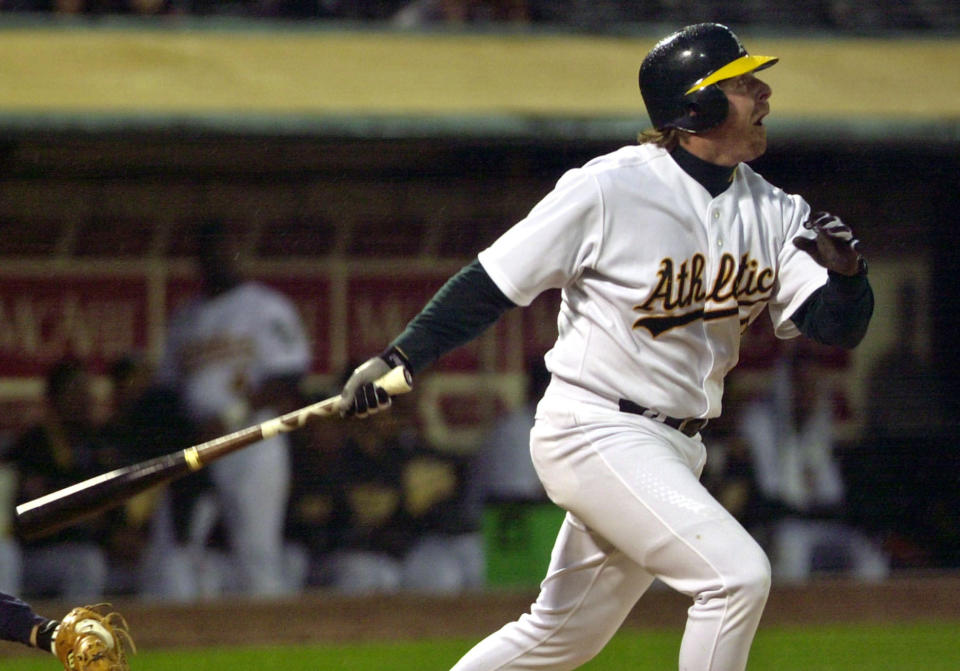 FILE - Oakland Athletics' Jeremy Giambi watches a home run off Seattle Mariners' Freddy Garcia during the third inning of a baseball game April 16, 2002, in Oakland, Calif. Giambi, the former major league outfielder and first baseman, died Wednesday, Feb. 9, 2022, at his parents' home in Southern California, police said. He was 47. (AP Photo/Ben Margot, File)