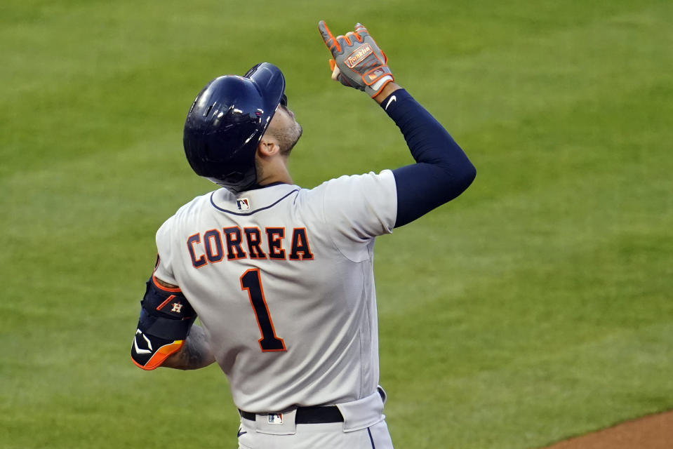 Houston Astros' Carlos Correa (1) points skyward after his RBI single during the first inning of a baseball game against the Los Angeles Angels Monday, April 5, 2021, in Anaheim, Calif. (AP Photo/Marcio Jose Sanchez)