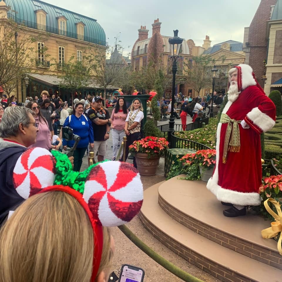 Pere Noel visits with guests of the France Pavilion at EPCOT, where the International Festival of the Holidays invites storytelling and sharing of traditions from around the globe.