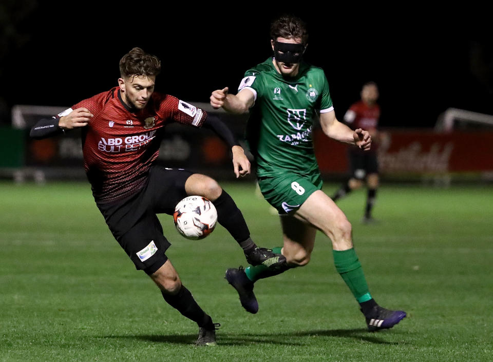 MELBOURNE, AUSTRALIA - AUGUST 09: Daniel Clark of Hume City is chased by Andy Brennan of Bentleigh Greens during the FFA Cup round of 32 match between Hume City FC and Bentleigh Greens at John Iilhan Memorial Reserve on August 9, 2017 in Melbourne, Australia.  (Photo by Robert Cianflone/Getty Images)