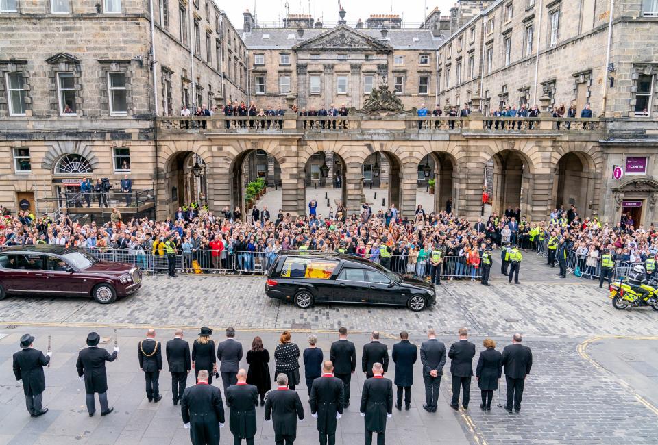 The hearse carrying the coffin of Queen Elizabeth II, draped with the Royal Standard of Scotland, passes the City Chambers on the Royal Mile, Edinburgh, Sunday, Sept. 11, 2022 on the journey from Balmoral to the Palace of Holyroodhouse in Edinburgh, where it will lie in rest for a day.