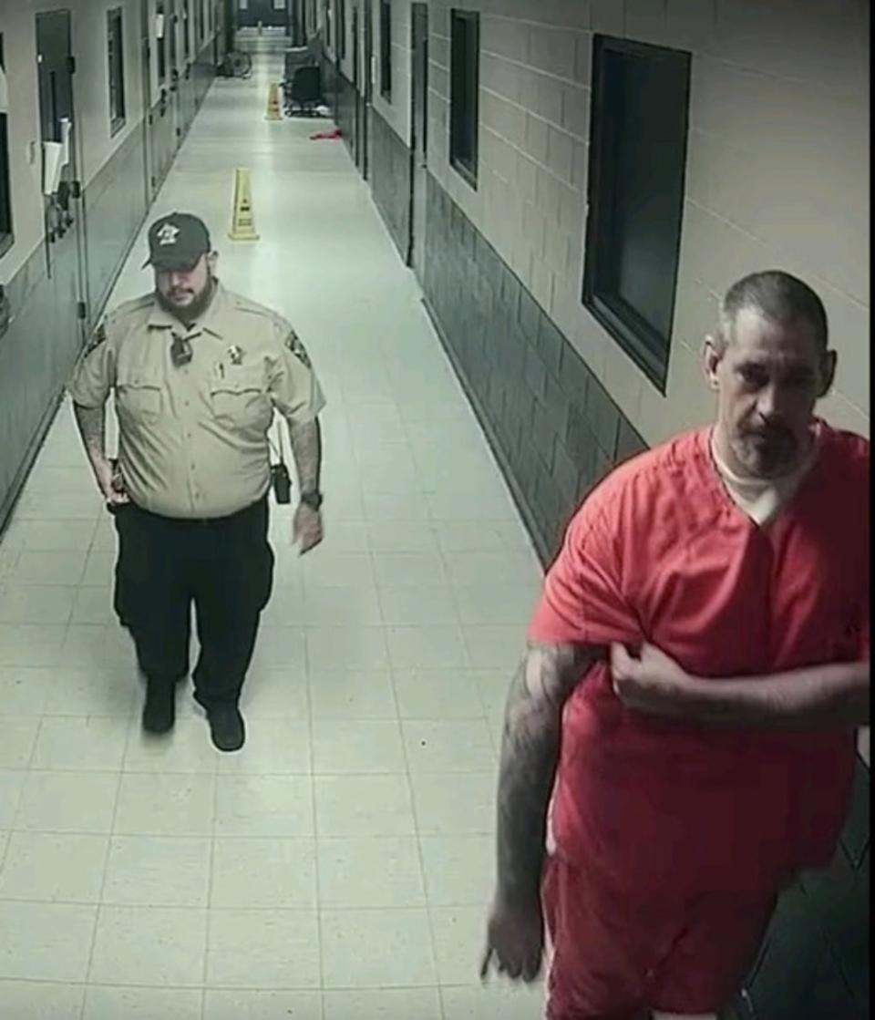 The suspected killer is seen reaching under his heavily-tattooed right arm (Lauderdale County Sheriff’s Office)