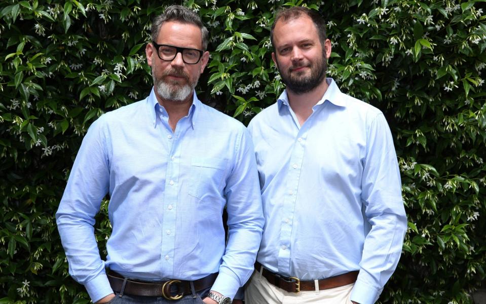 Cancer survivors Daniel Marks (left) and Jack Dyson (right) wearing blue shirts in support of their charity, Father and Son Day - Daniel Marks