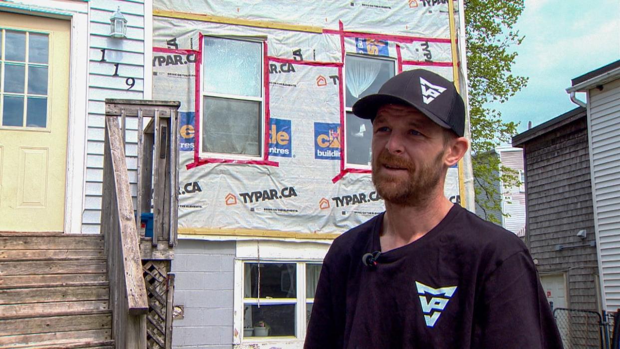 Cory Hamilton stands in front of the apartment he rents at 119 Guilford St. in Saint John. (Roger Cosman/CBC - image credit)