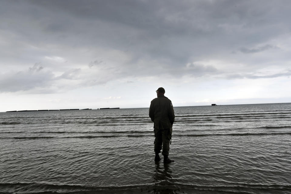 An enthusiast stands on the beach of Arromanches, Tuesday, June 4, 2019 in Normandy. Extensive commemorations are being held in the U.K. and France this week to honor the nearly 160,000 troops from Britain, the United States, Canada and other nations who landed in Normandy on June 6, 1944 in history's biggest amphibious invasion. (AP Photo/Thibault Camus)