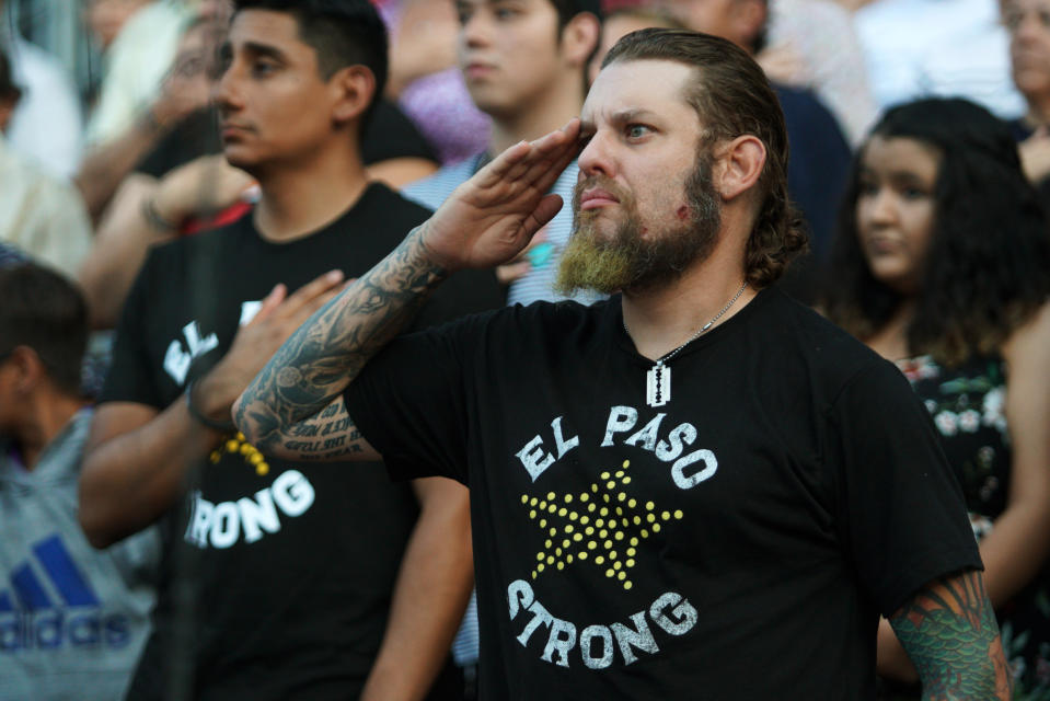 A man salutes during a memorial service for the victims of the Aug. 3 mass shooting, Wednesday, Aug. 14, 2019, at Southwest University Park, in El Paso, Texas. (AP Photo/Jorge Salgado)