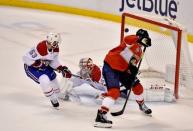 Feb 17, 2019; Sunrise, FL, USA; Florida Panthers center Aleksander Barkov (16) controls the puck past Montreal Canadiens defenseman Victor Mete (left) for a goal against goaltender Antti Niemi (center) during the second period at BB&T Center. Mandatory Credit: Steve Mitchell-USA TODAY Sports