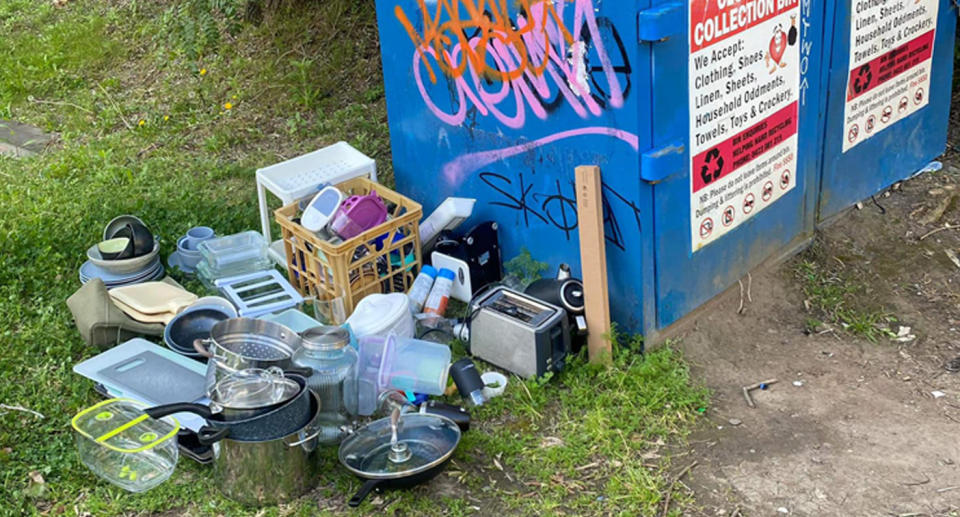 A photo of kitchen utensils and other items dumped next to a donation bin in Camperdown, Sydney.