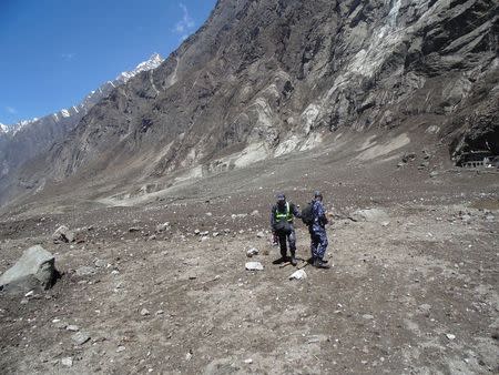 Soldiers search for bodies after a massive avalanche triggered by last week's earthquake overwhelmed Langtang village, Nepal, in this May 2, 2015 police handout photo. Rescue workers are struggling to recover the bodies of nearly 300 people, including about 110 foreigners, believed to be buried under up to six metres (20 feet) of ice, snow and rock from the landslide that destroyed Langtang village. Picture taken May 2, 2015. REUTERS/Handout via Reuters ATTENTION EDITORS - NO SALES. NO ARCHIVES. FOR EDITORIAL USE ONLY. NOT FOR SALE FOR MARKETING OR ADVERTISING CAMPAIGNS. THIS PICTURE WAS PROVIDED BY A THIRD PARTY. REUTERS IS UNABLE TO INDEPENDENTLY VERIFY THE AUTHENTICITY, CONTENT, LOCATION OR DATE OF THIS IMAGE. THIS PICTURE IS DISTRIBUTED EXACTLY AS RECEIVED BY REUTERS, AS A SERVICE TO CLIENTS.