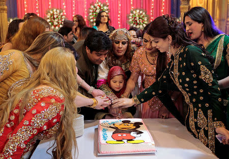 Guests cut a cake at Shakeela's party in Peshawar, Pakistan January 22, 2017. REUTERS/Caren Firouz