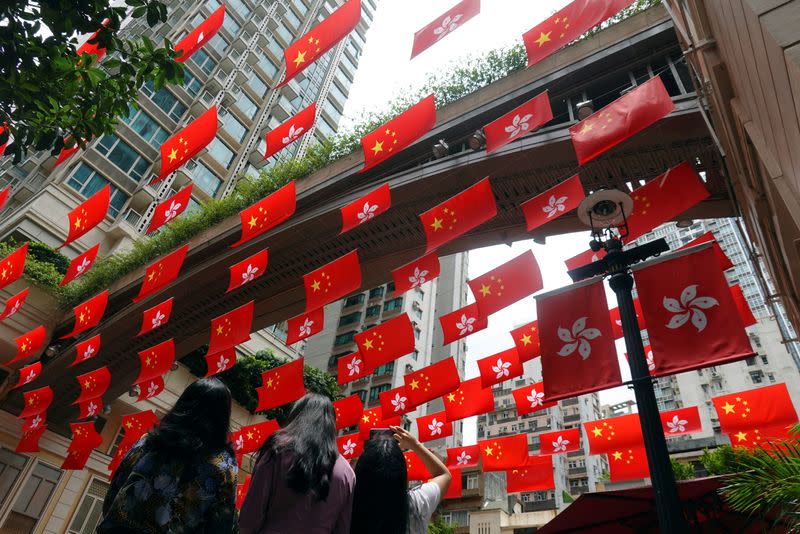 Chinese and Hong Kong flags decorate a street in Hong Kong