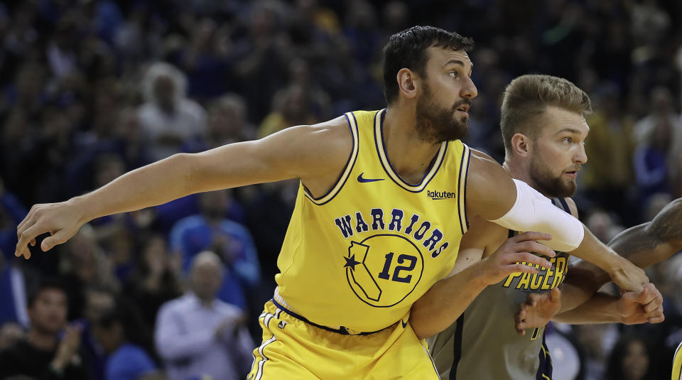 Golden State Warriors' Andrew Bogut (12) blocks out Indiana Pacers' Domantas Sabonis, right, during the first half of an NBA basketball game Thursday, March 21, 2019, in Oakland, Calif. (AP Photo/Ben Margot)