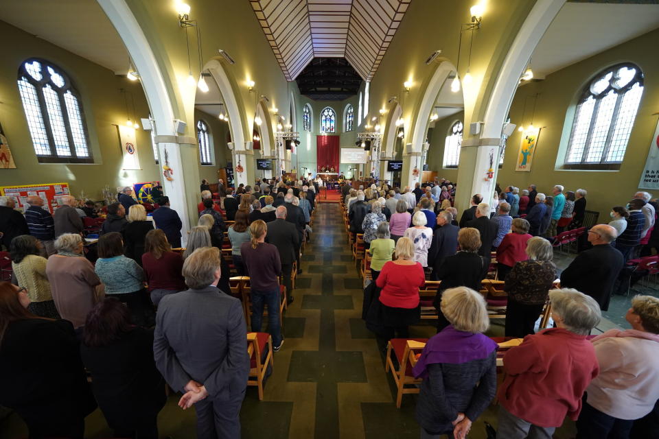 People attend a vigil at St Michael & All Angels church in Leigh-on-Sea in Essex, England, Sunday Oct. 17, 2021 for Conservative MP Sir David Amess who died after he was stabbed several times at a constituency surgery on Friday. (Kirsty O'Connor/PA via AP)