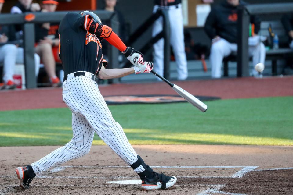 Oklahoma State outfielder Nolan Schubart (10) hits a home run during a college baseball game between the Oklahoma State Cowboys (OSU) and the Baylor Bears at O’Brate Stadium in Stillwater, Okla., on Saturday, March 25, 2023.