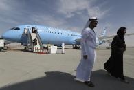 People visit an Ethihad plane during the opening day of Dubai Airshow in Dubai, United Arab Emirates, Sunday, Nov. 17, 2019. The biennial Dubai Airshow has opened as major Gulf airlines reign back big-ticket purchases after a staggering $140 billion in new orders were announced at the 2013 show before global oil prices collapsed.(AP Photo/Kamran Jebreili)