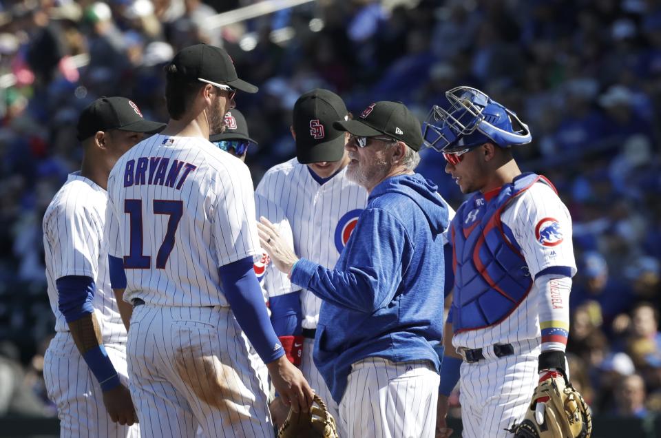 Chicago Cubs manager Joe Maddon makes a mound visit during the second inning of the team’s spring training baseball game against the Texas Rangers, Saturday, Feb. 24, 2018, in Mesa, Ariz. (AP Photo/Carlos Osorio)