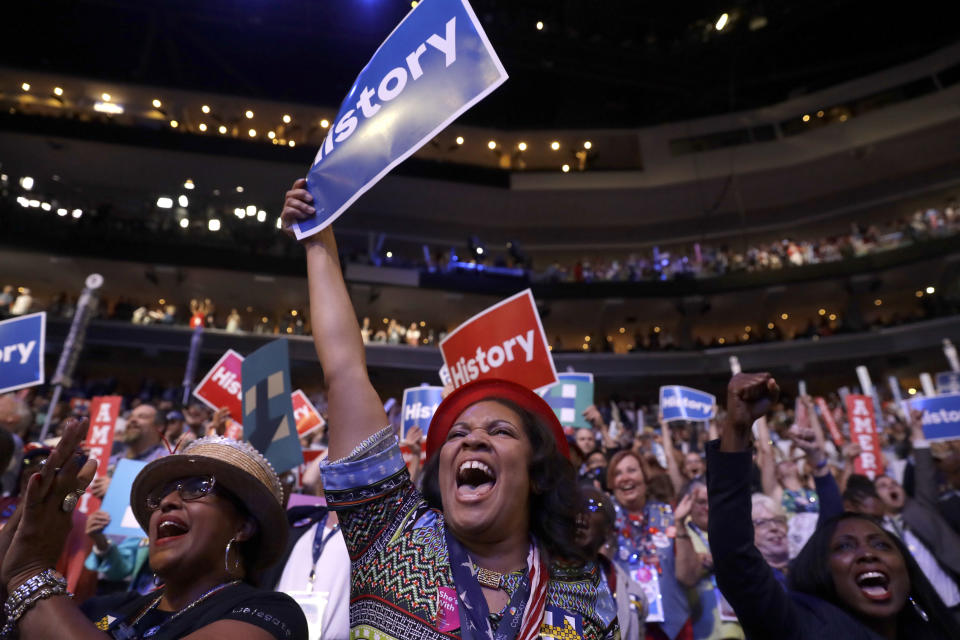 FILE - In this July 26, 2016, file photo, delegates cheer as Democratic Presidential candidate Hillary Clinton appears on the screen during the second day session of the Democratic National Convention in Philadelphia. Democratic presidential candidate former Vice Presiden JoBiden’s presidential nominating convention will highlight the U.S. political spectrum from the left flank of New York Rep. Alexandria Ocasio-Cortez to the Republican old guard of former Ohio Gov. John Kasich. But that doesn’t mean there’s room for every prominent Democrat who would get a share of the spotlight at a routine convention taking place without the backdrop of a pandemic. (AP Photo/Matt Rourke, File)