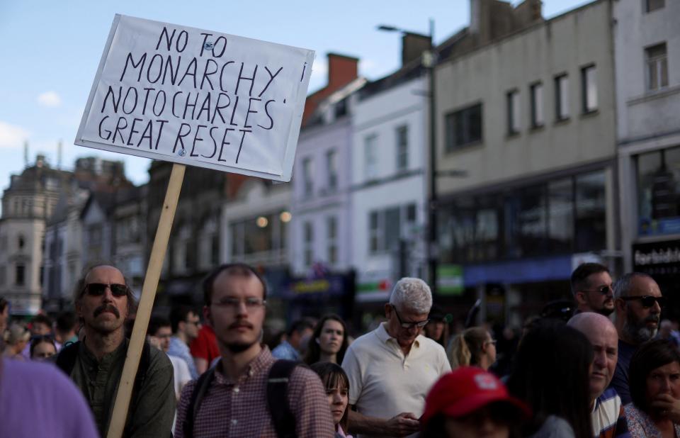 A person holds a sign during a protest outside Cardiff Castle on the day of a visit by Britain's King Charles (REUTERS)