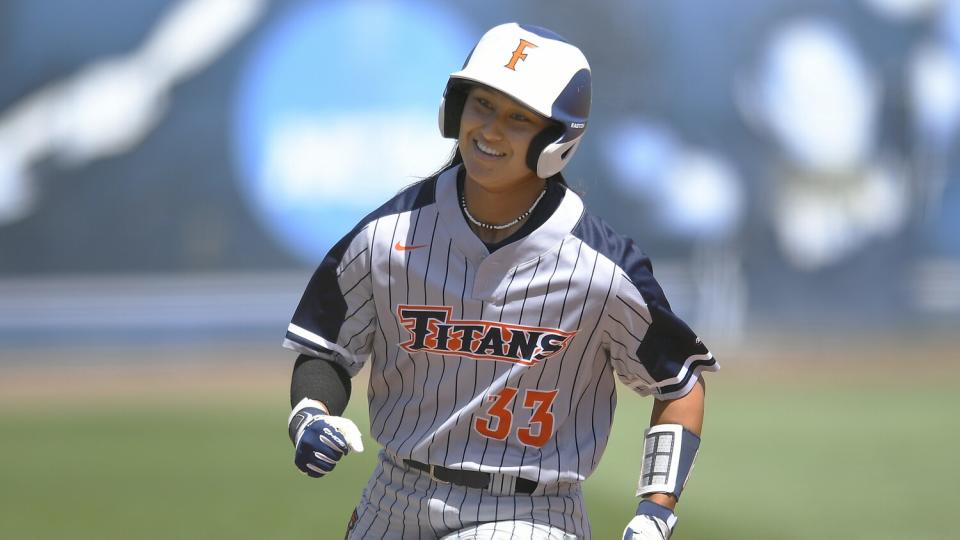 Cal State Fullerton's Kelsie Whitmore reacts while running the bases during a softball game