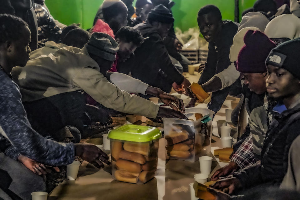 Following evening prayers at Bronx's Masjid Ansaru-Deen mosque, African migrants break Ramadan fast and begin a meal called an iftar, Friday March 15, 2024, in New York. The mosque, formerly the family home for its Imam Omar Niass, has been a refuge and shelter since 2020 for African migrants seeking asylum in the United States. (AP Photo/Bebeto Matthews)