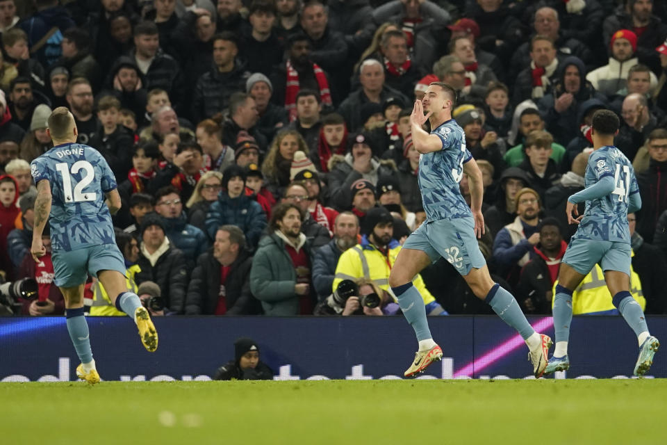 Aston Villa's Leander Dendoncker, centre right, celebrates after scoring his side's second goal during the English Premier League soccer match between Manchester United and Aston Villa at the Old Trafford stadium in Manchester, England, Tuesday, Dec. 26, 2023. (AP Photo/Dave Thompson)