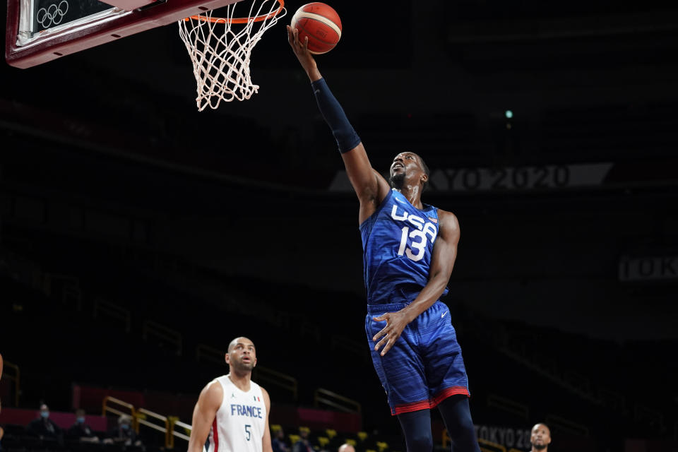 United States' Bam Adebayo (13) drives to the basket ahead of France's Nicolas Batum, left, during a men's basketball preliminary round game at the 2020 Summer Olympics, Sunday, July 25, 2021, in Saitama, Japan. (AP Photo/Charlie Neibergall)