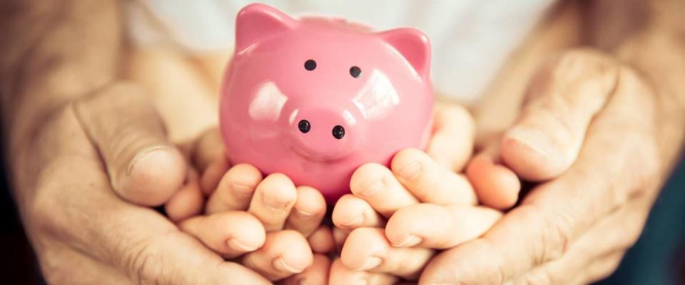 Family holding piggybank in hands