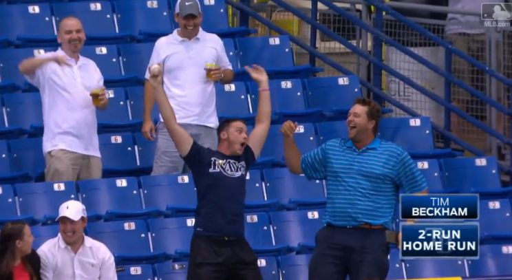 A fan waves his arms after catching Tim Beckham's second inning home run. (MLB.TV)