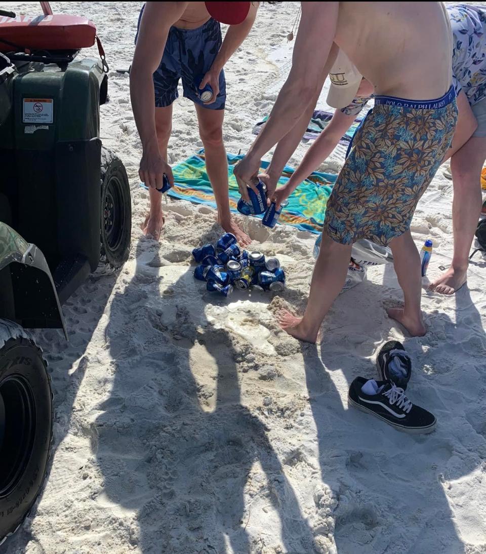 A group of teens dump out cans of beer after being caught by Okaloosa County Sheriff's Office deputies during Spring Break this year. Close to 700 people were arrested for underage possession of alcohol and other spring break-related offenses in Walton and Okaloosa counties.