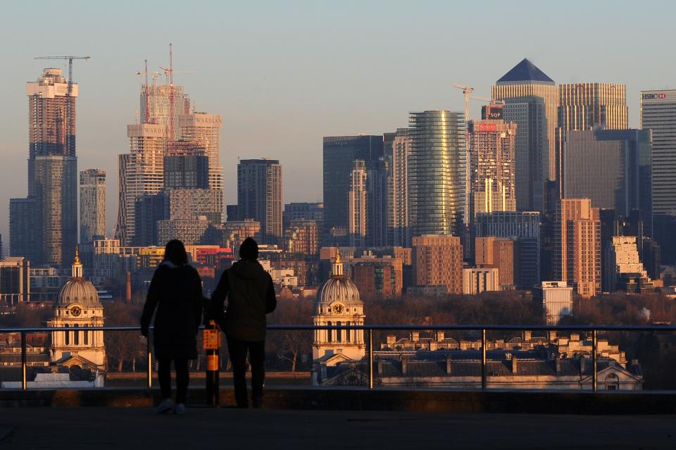 People take in the view of the towers and offices at Canary Wharf from the viewing area in Greenwich Park in London. Photo: Daniel Sorabji‏/AFP/Getty Images