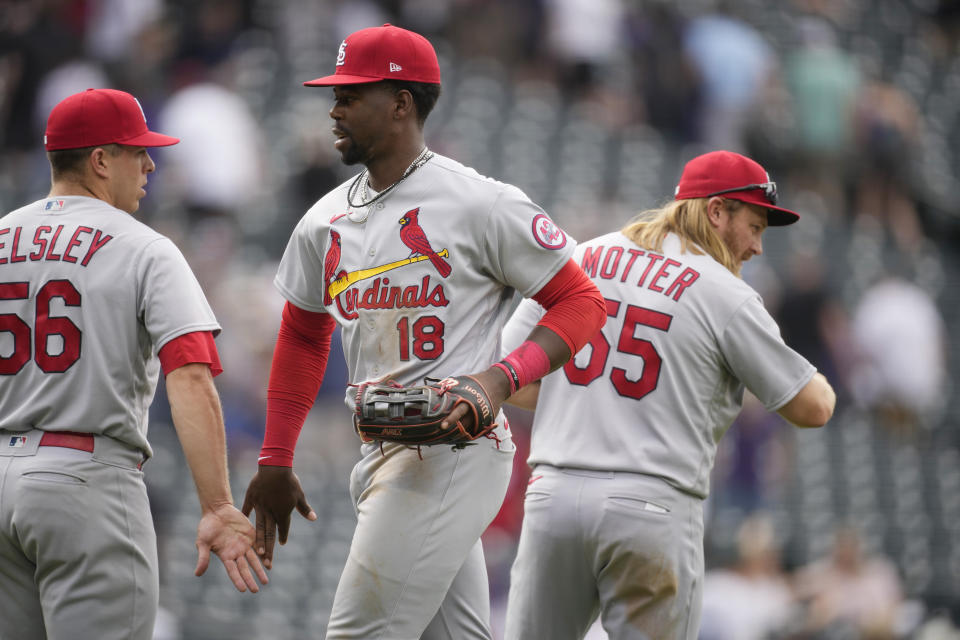 St. Louis Cardinals relief pitcher Ryan Helsley, left, congratulates right fielder Jordan Walker after the team's win over the Colorado Rockies in a baseball game Wednesday, April 12, 2023, in Denver. At right is third baseman Taylor Motter. (AP Photo/David Zalubowski