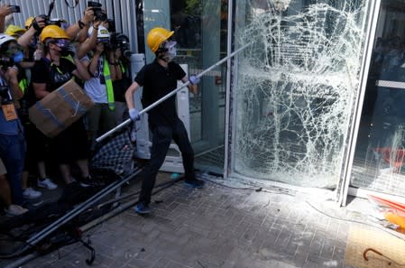 Protesters try to break into the Legislative Council building during the anniversary of Hong Kong's handover to China in Hong Kong