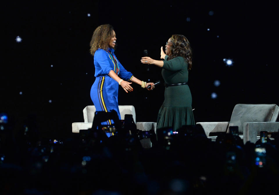 Michelle Obama, left, and Oprah Winfrey greet each other onstage at "Oprah's 2020 Vision: Your Life in Focus" tour at the Barclays Center on Saturday, Feb. 8, 2020, in New York. (Photo by Brad Barket/Invision/AP)