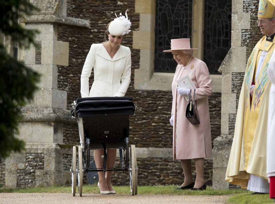 <p>The Queen coos over her granddaughter Princess Charlotte at her christening in Norfolk, as proud mum Kate looks on.<em> [Photo: PA]</em> </p>