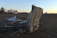 Debris from a farm building nearby sits in a field along North Tolles Road in Evansville, Wis., Friday morning, Feb. 9, 2024, after a confirmed tornado traveled through the area just northwest of Evansville, Wis., the prior evening. The tornado was the first-ever reported in February in the state of Wisconsin, according to the National Weather Service. (Anthony Wahl//The Janesville Gazette via AP)
